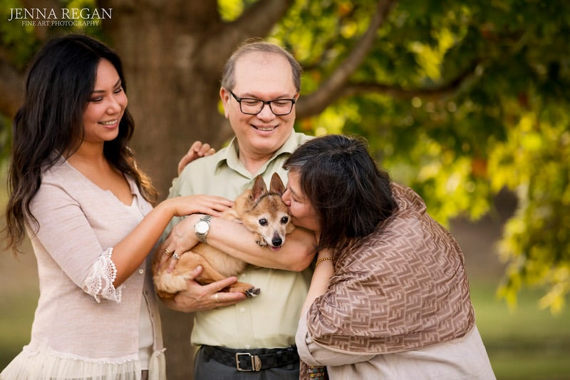 mother, father, and daughter with chihuahua senior dog outdoor photo shoot
