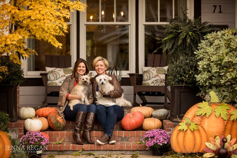 same sex couple with their dogs on steps at their home during dog photography session in dallas tx
