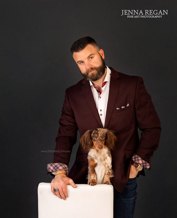 man with his dog on chair in studio pet photo shoot